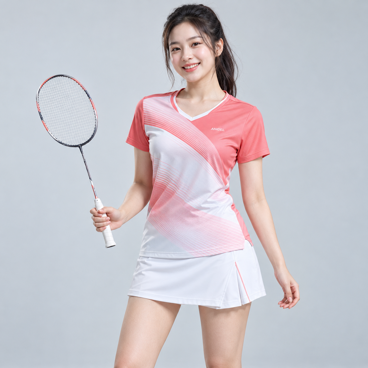 Cầu lông ANGEL Áo cầu lông nữ hồng san hô phối trắng với đường kẻ mảnh, kết hợp chân váy trắng.
